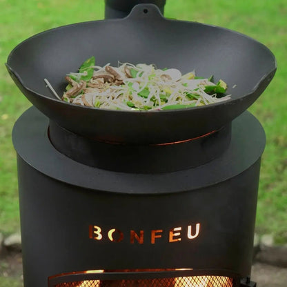 Black cast iron wok resting on bonfeu bontino lp outdoor fireplace stove in black for outdoor cooking