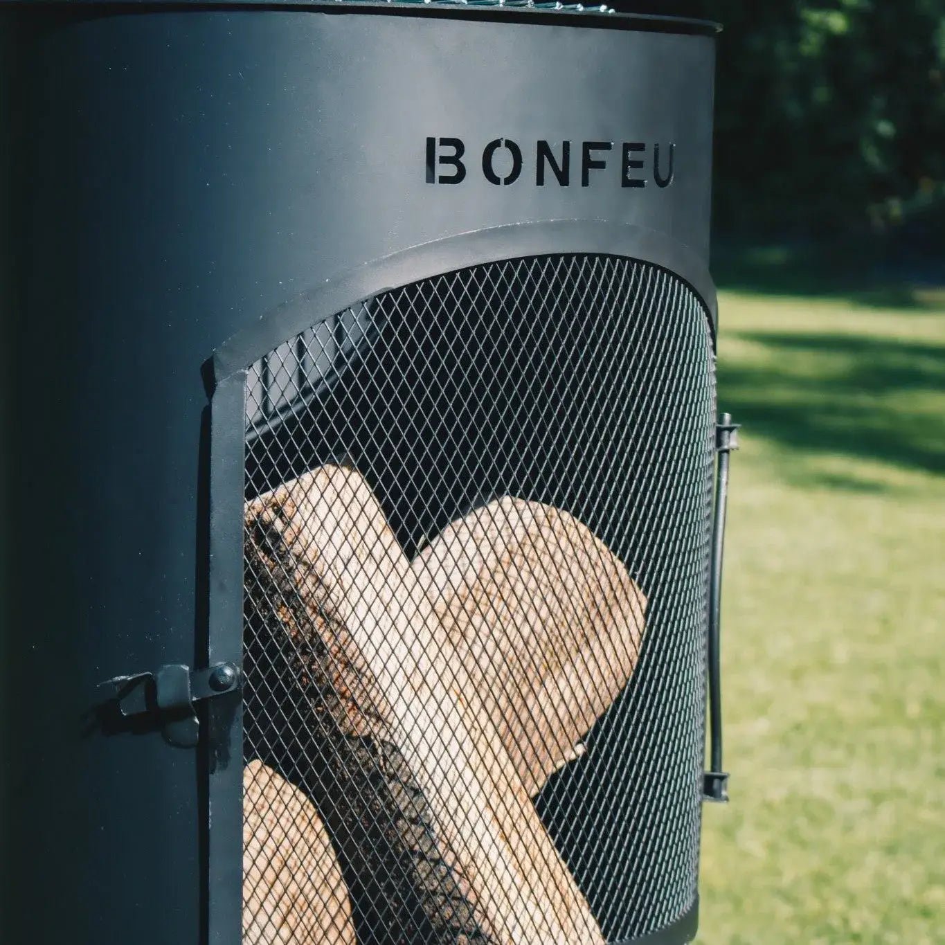 Black metal bonfeu bontino lp outdoor fireplace with mesh door and bonfeu branding for outdoor use