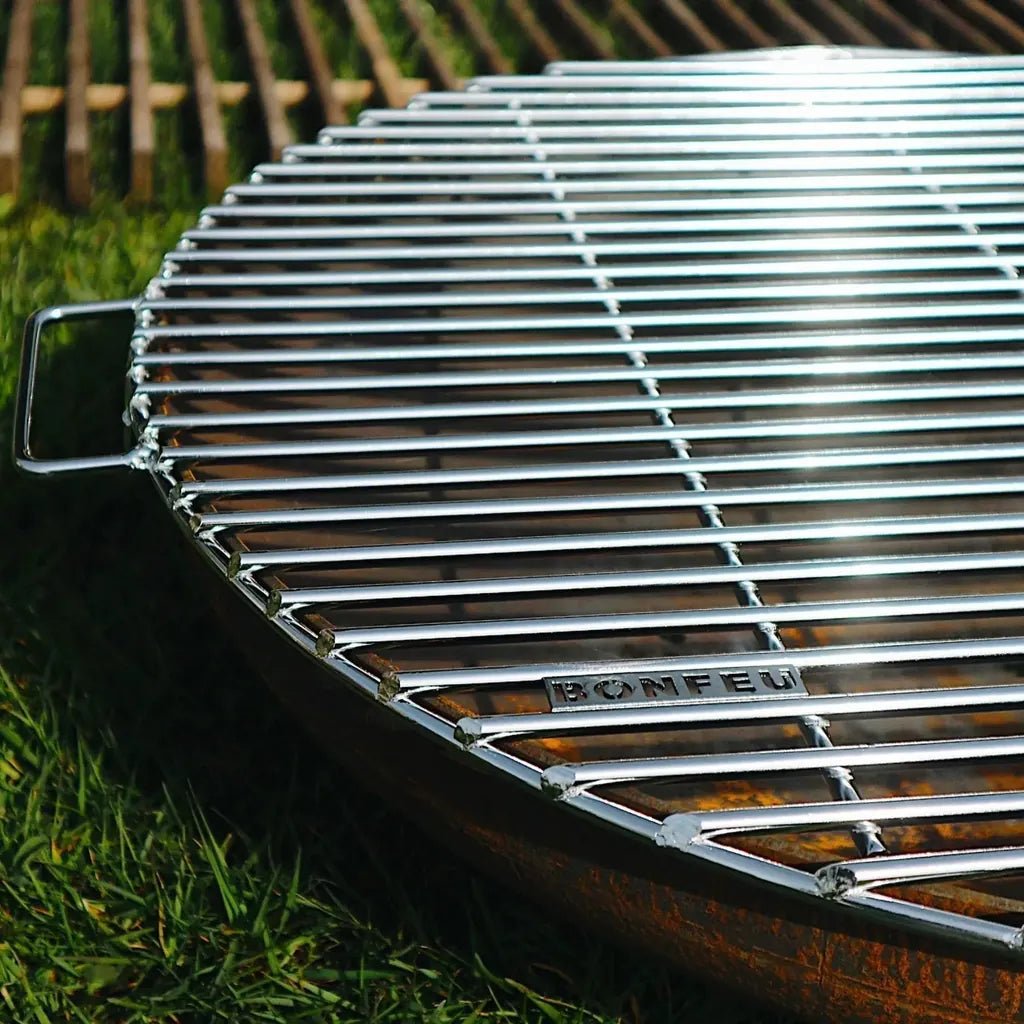 Chrome-finished metal grill grate with bonfeu engraving designed for bonbowl fire bowl pit bbqs