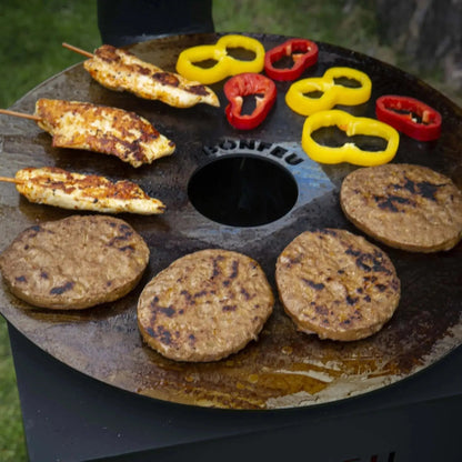 Black circular cast iron bonfeu plancha with central hole for bonfeu outdoor fireplaces cooking surface
