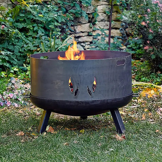 Black metal fire pit with eye-shaped cutouts and three legs by Buschbeck decorative fire pit surround 80cm