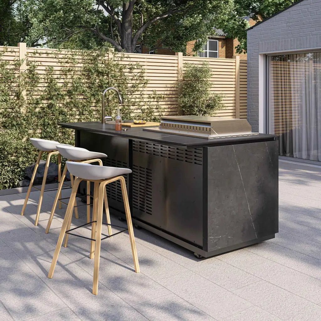 Buschbeck Derby outdoor kitchen grey marbled ceramic finish with black island, stainless steel grill, sink, and light wood stools