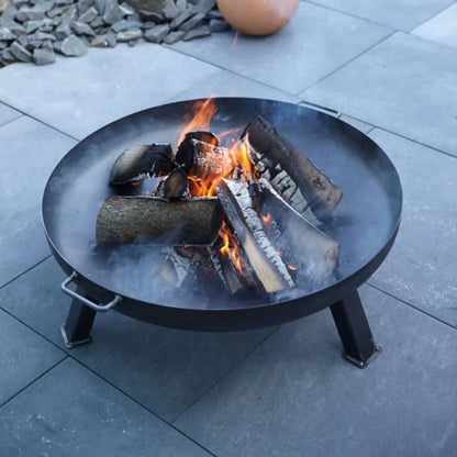 Buschbeck ifen steel fire pit 60cm black metal with four legs and side handle burning logs and flames