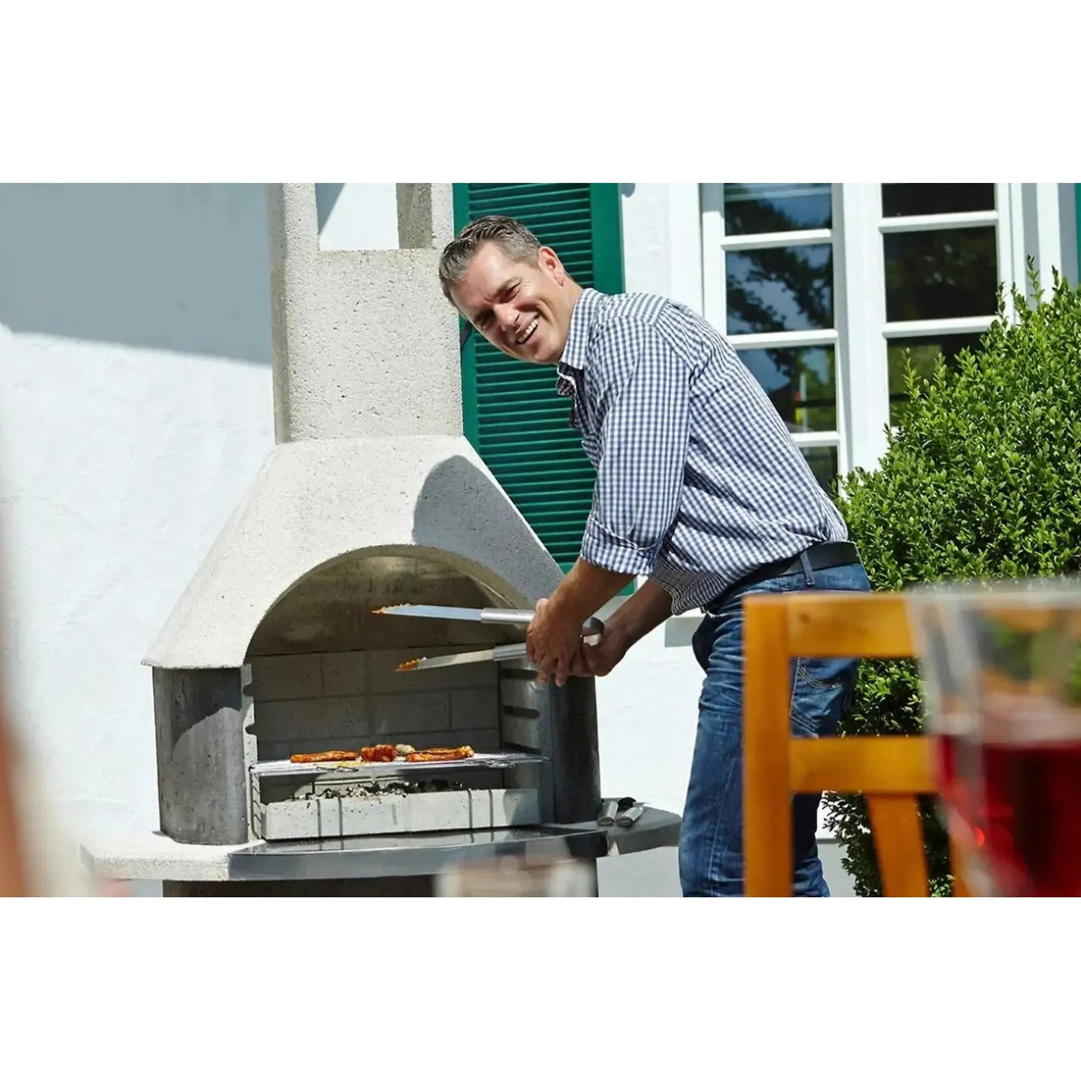Buschbeck milano masonry barbecue stone pizza oven with curved arch metal interior and sleek gray exterior