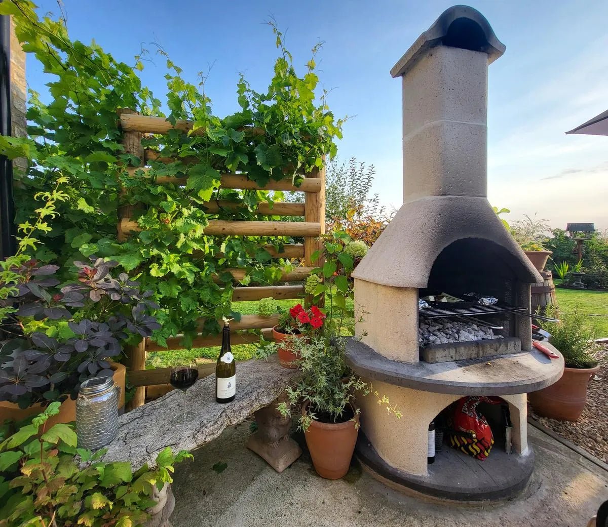Beige stone buschbeck verona masonry barbecue with curved chimney and built-in grill for outdoor cooking