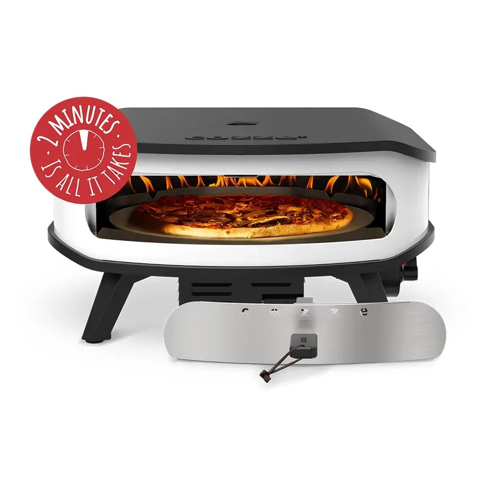 Black and stainless steel cozze 17 inch gas pizza oven with rotating stone and visible flame cooking pizza inside