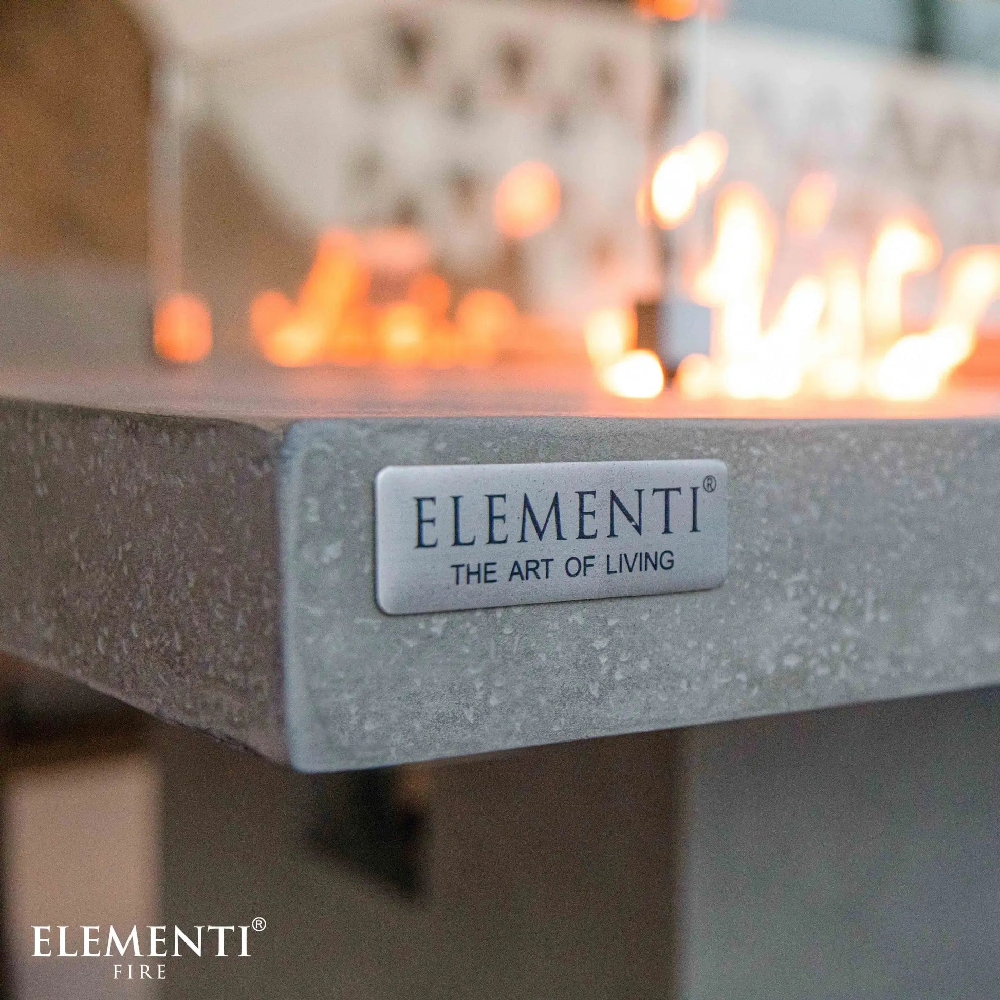 Silver metallic plaque with elementi and the art of living engraved on the elementi birmingham dining fire table