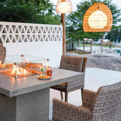 Gray concrete Elementi Birmingham dining fire table with 13.2 kW flames enclosed in glass for outdoor use