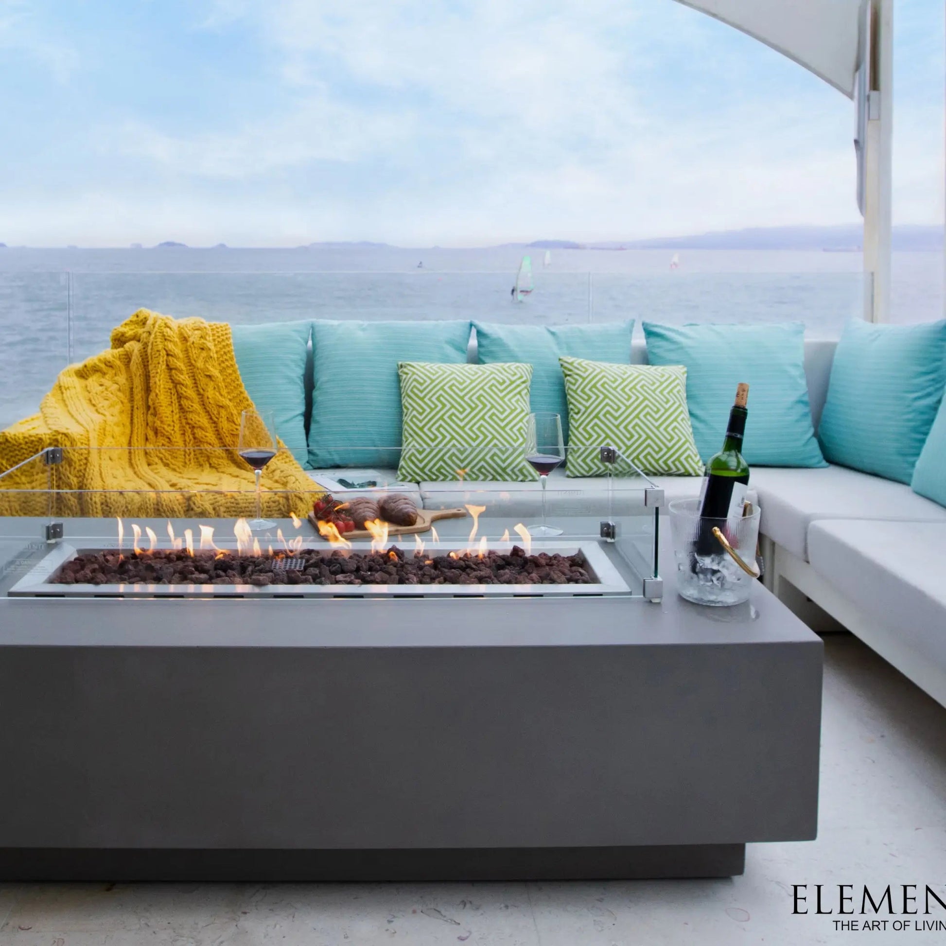 Modern gray elementi granville fire table with glass enclosure and glowing flames 13.2 kW heating power