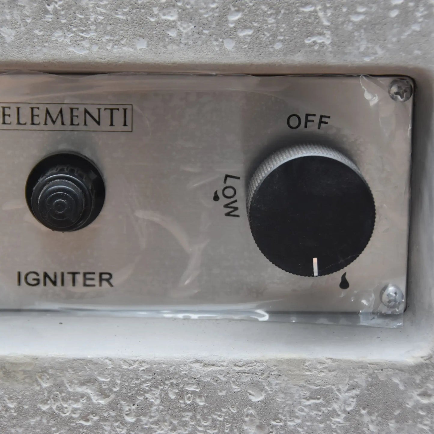 Silver metallic control panel with black rotary knob and igniter button on elementi hampton fire table 13.2 kw