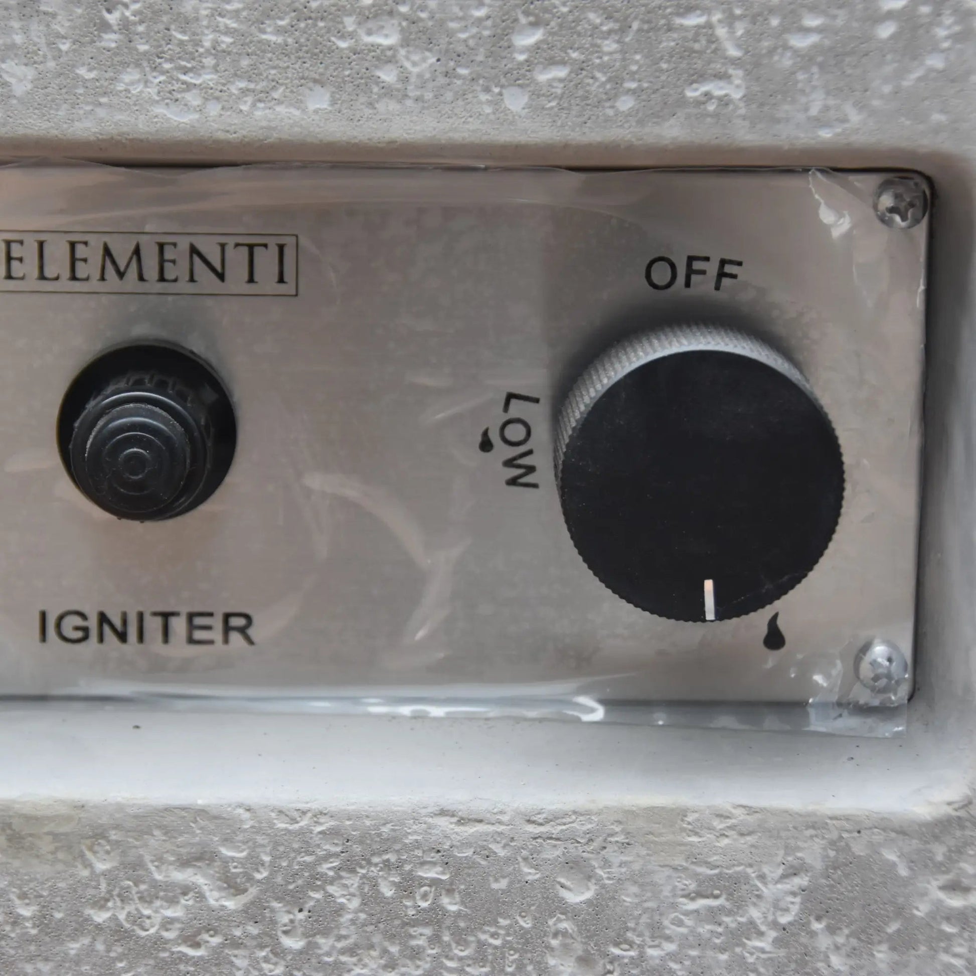 Silver metallic control panel with black rotary knob and igniter button on elementi hampton fire table 13.2 kw