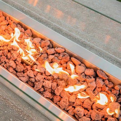 Elementi hampton fire table rectangular stainless steel fire pit with orange lava rocks and glowing flames 13.2 kw