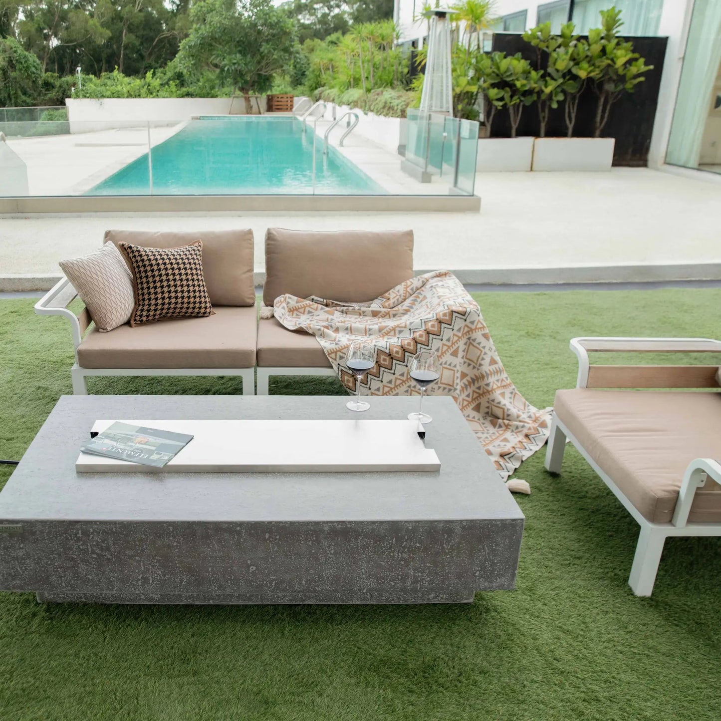 Gray concrete Elementi Hampton fire table with sleek modern design and smooth white rectangular inset top 13.2 kW