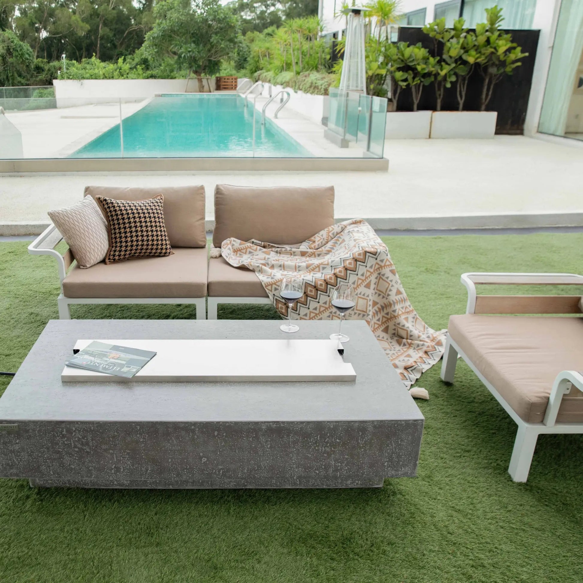 Gray concrete Elementi Hampton fire table with sleek modern design and smooth white rectangular inset top 13.2 kW