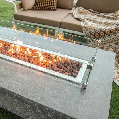 Elementi Hampton fire table with modern rectangular design clear glass enclosure lava rocks and glowing orange flames