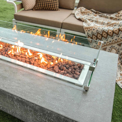 Modern rectangular Elementi Hampton fire table with sleek silver metal frame clear glass enclosure and glowing orange flames