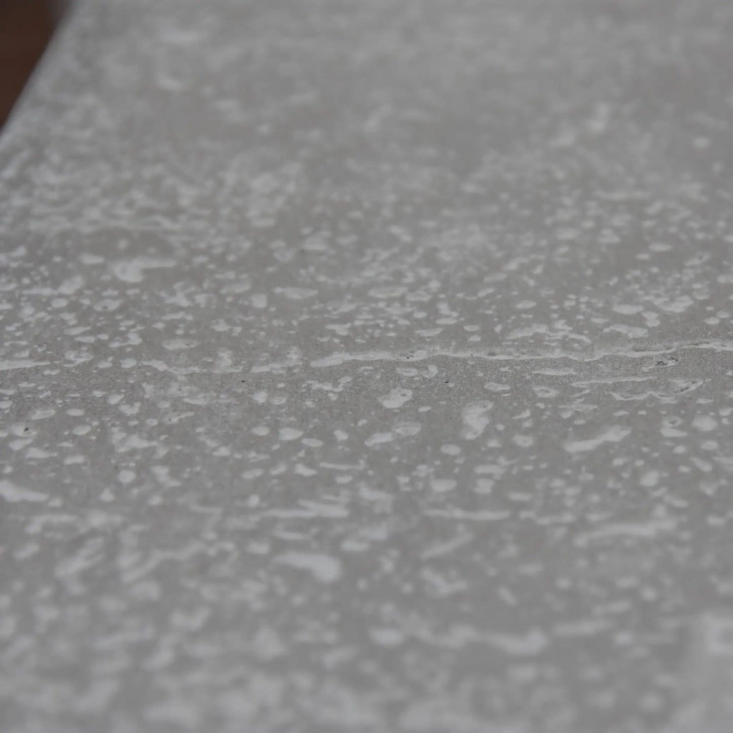 Gray textured surface with a speckled pattern on the elementi hampton fire table 13.2 kw model ofg139lg