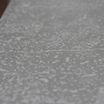Gray textured surface with a speckled pattern on the elementi hampton fire table 13.2 kw model ofg139lg