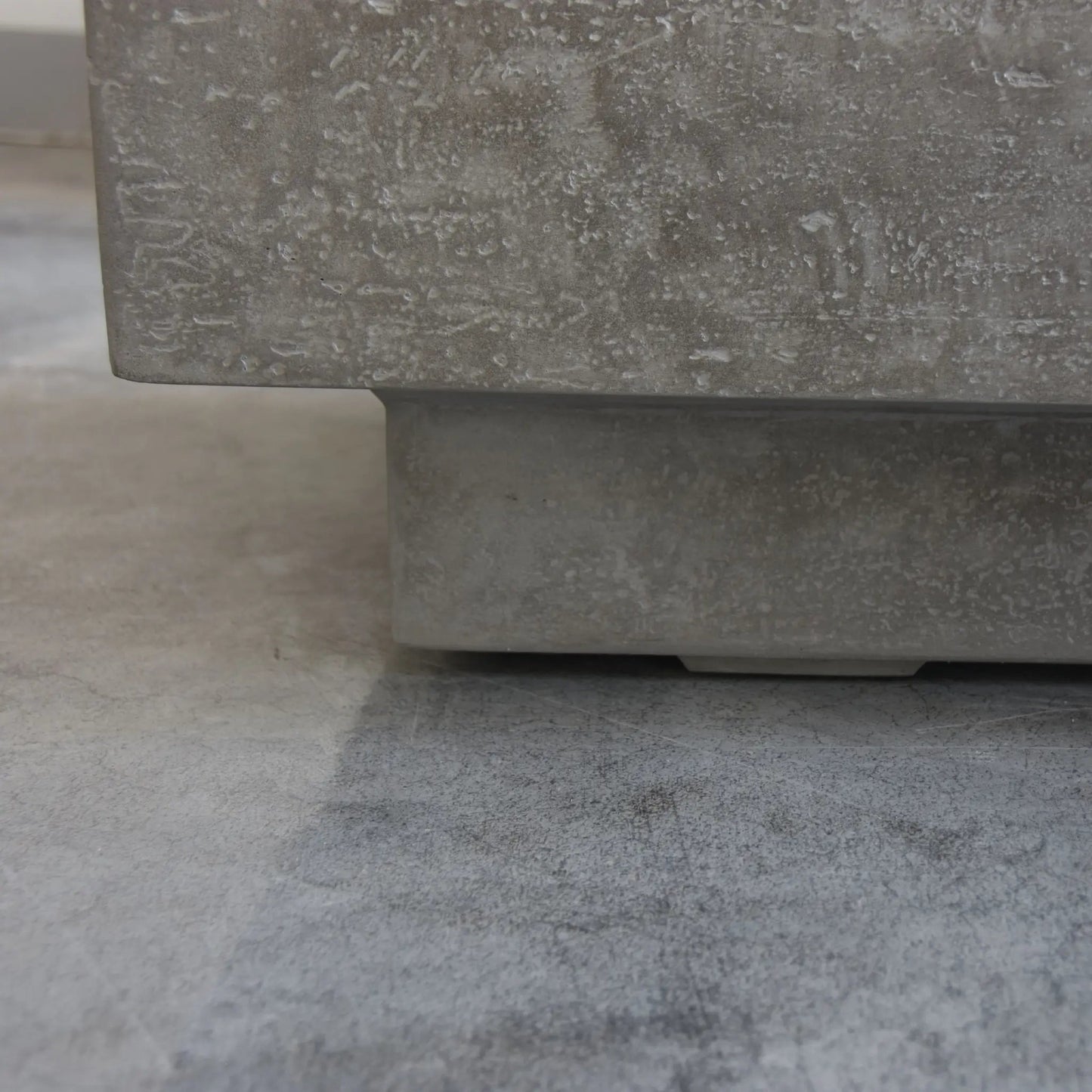 Gray concrete planter with textured speckled surface and rectangular base for elementi kingsale fire table 13.2 kw