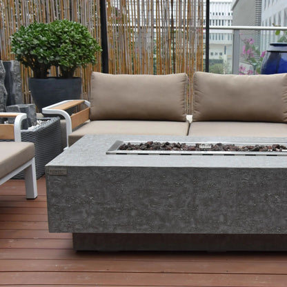 Elementi Kingsale fire table gray concrete with rectangular metal insert holding dark pebbles 13.2 kW heating