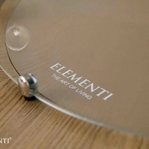 Clear glass plate with elementi the art of living engraved in silver on elementi lafite barrel bar fire table base