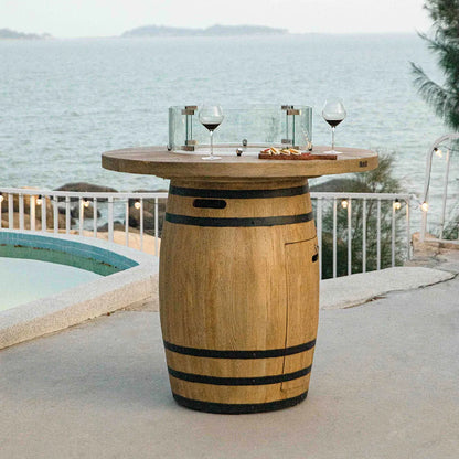 Wooden barrel table with glass fire pit and wine glasses on top in elementi lafite barrel bar fire table 13.2 kw