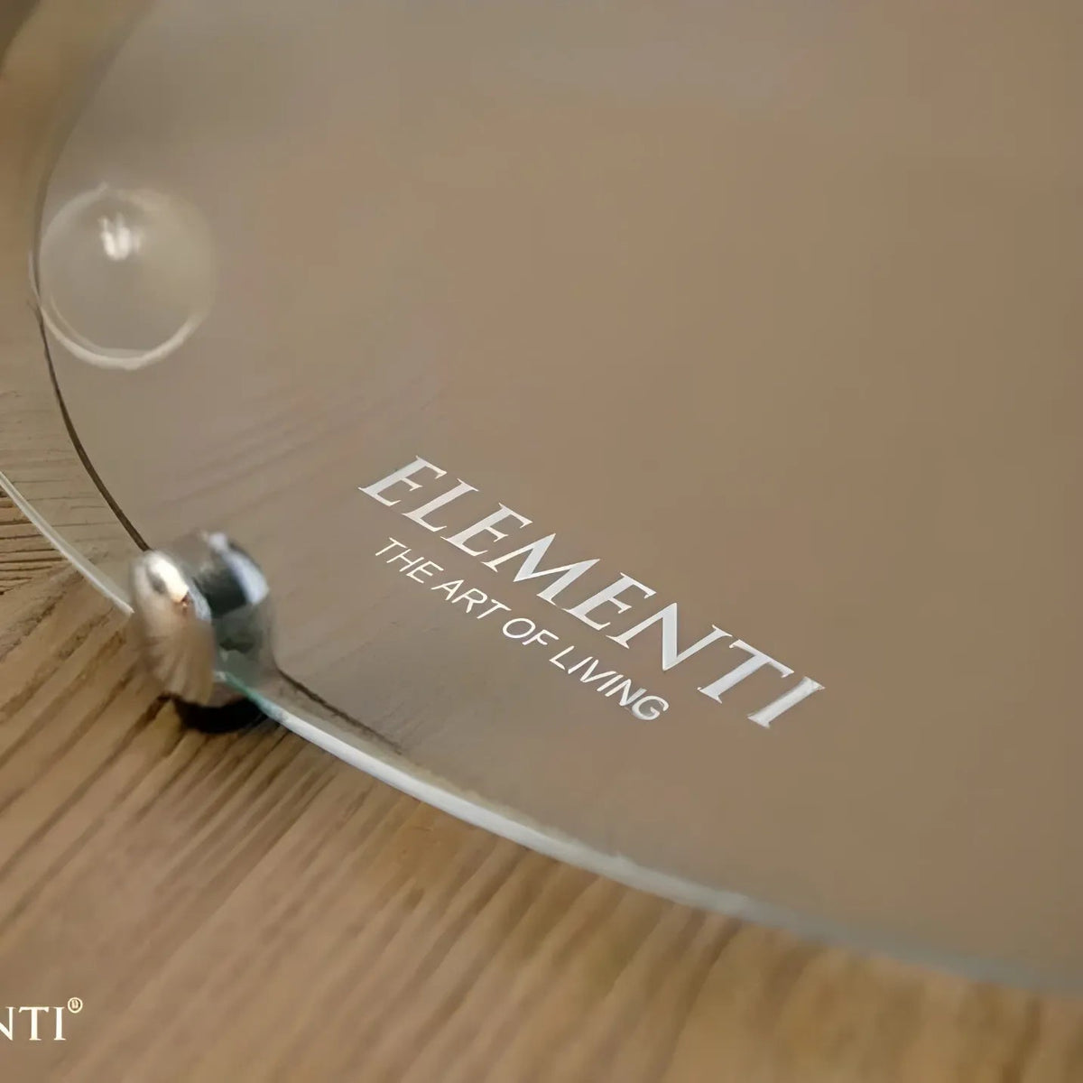 Clear glass serving tray with sleek modern design and silver metal feet for elementi lafite barrel bar fire table