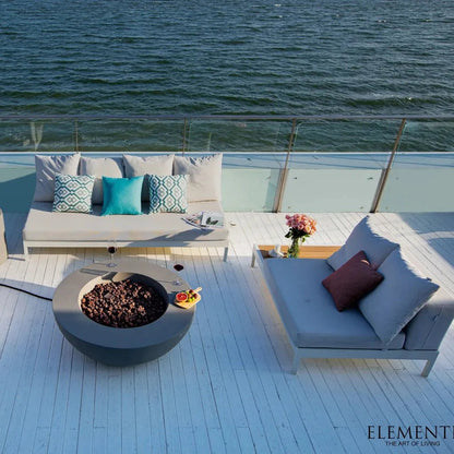 Elementi lunar bowl fire table in light grey concrete with dark brown pebbles inside for outdoor use