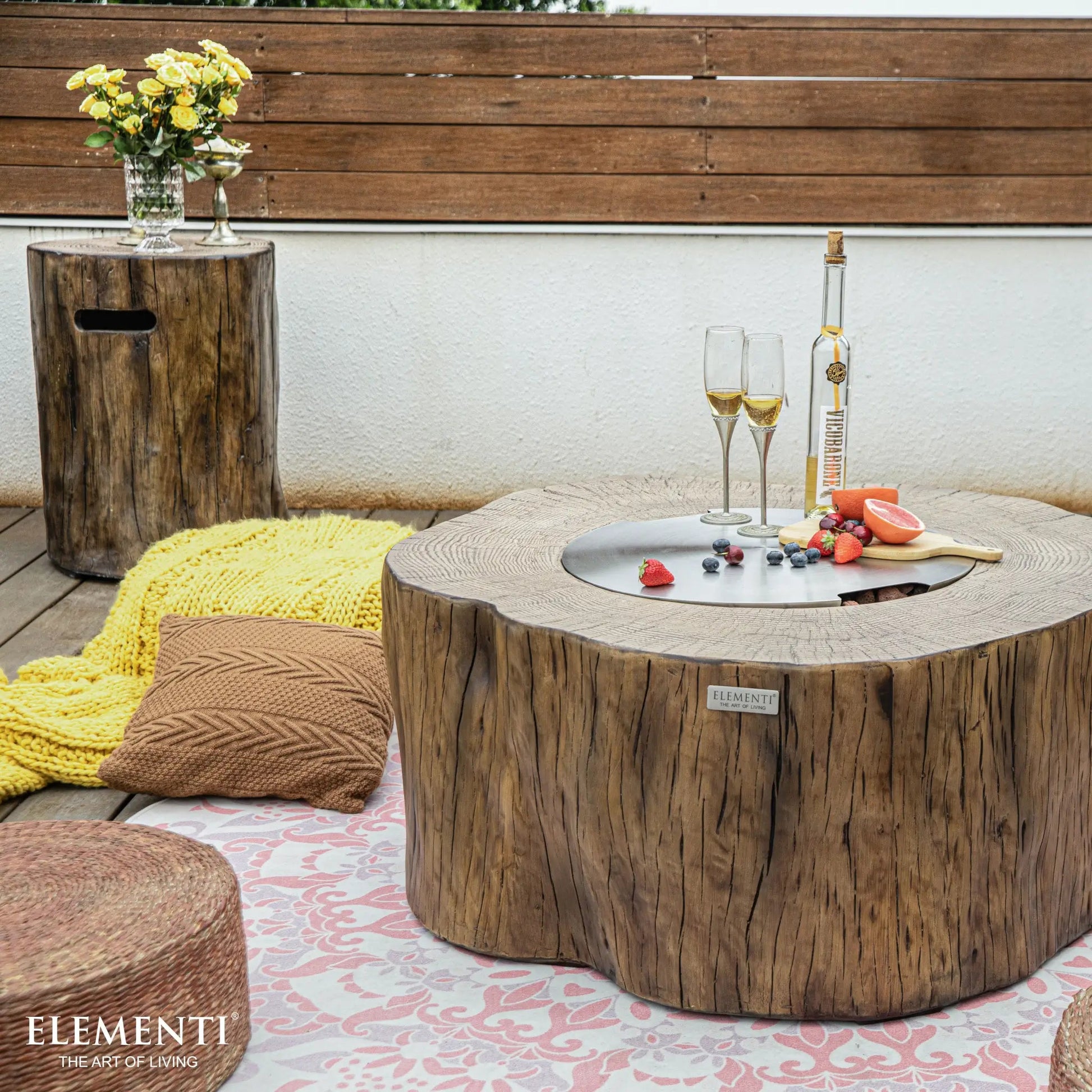 Rustic wooden coffee table with a circular metal top and natural wood grain finish from elementi manchester fire table 13.2 kW