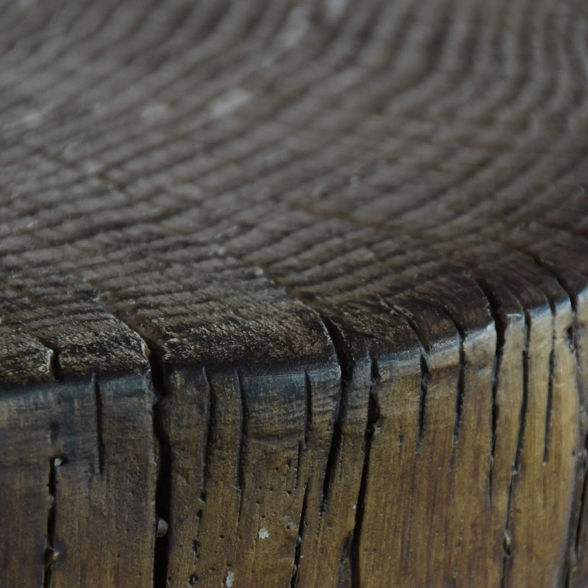 Weathered wooden stump with visible grain and darkened cracked edges featured in elementi manchester fire table 13.2 kw