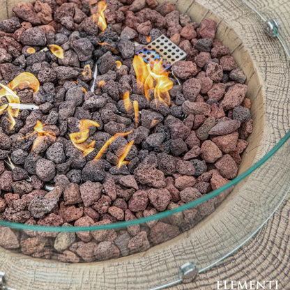 Elementi Manchester fire table with glass rim 13.2 kW burner and reddish brown dark gray lava rocks in circular fire pit