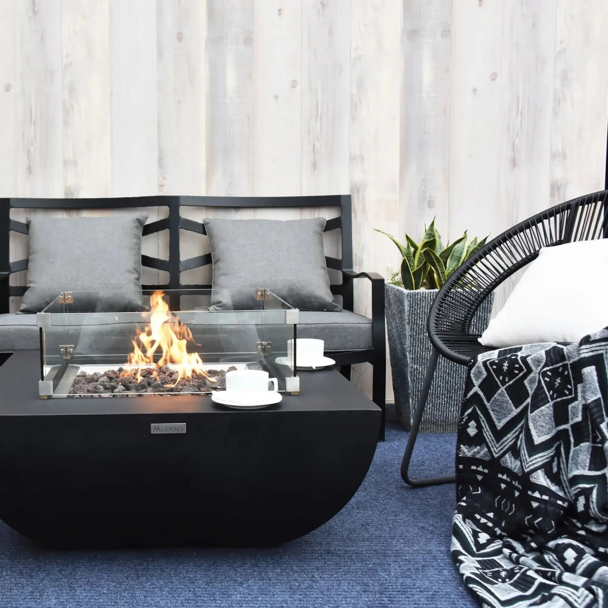 Black modern Elementi Modeno Aurora fire table with glass enclosure and burning flame 14.7 kW OFG114