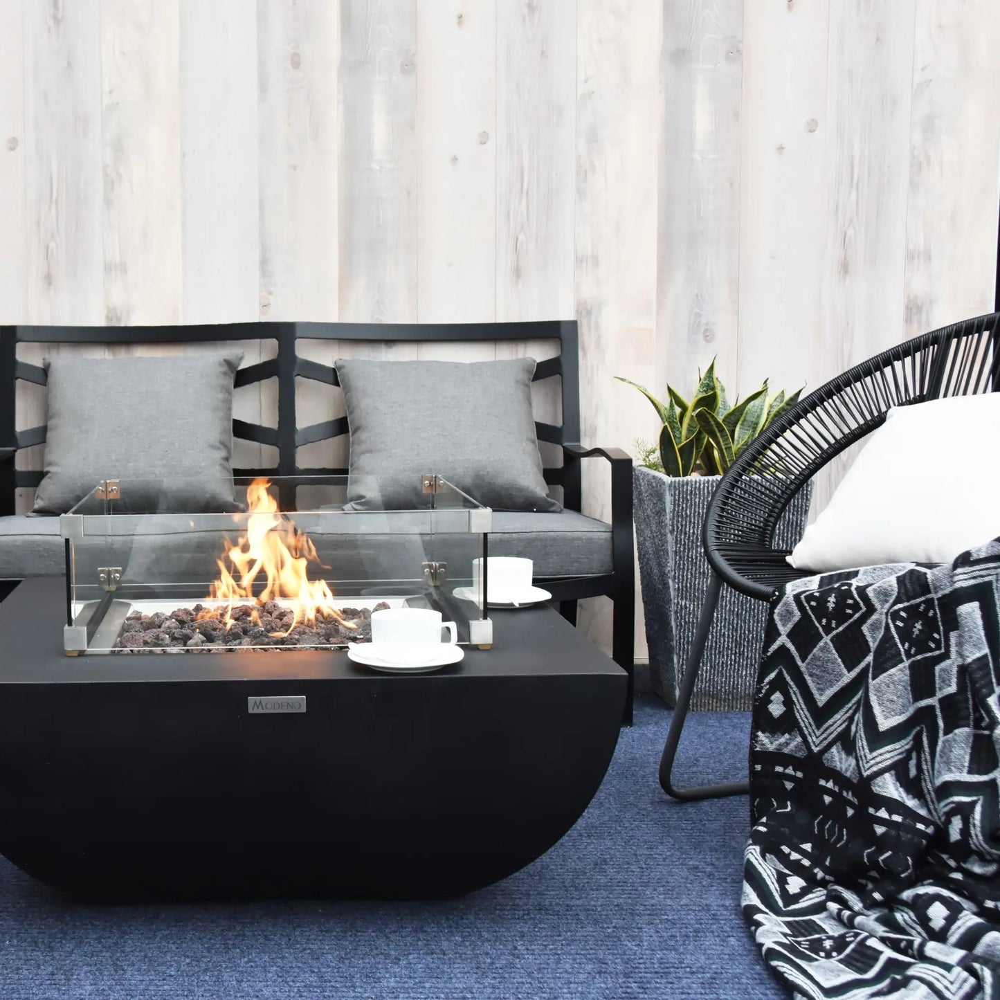 Black modern Elementi Modeno Aurora fire pit table with glass enclosure and burning flame 14.7 kW OFG114