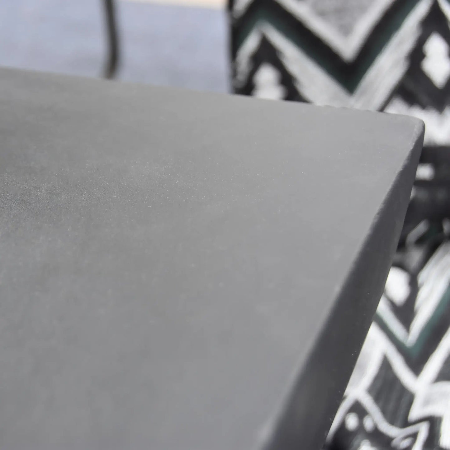 A sleek matte gray rectangular corner of the Elementi Modeno Aurora fire table with a smooth modern finish