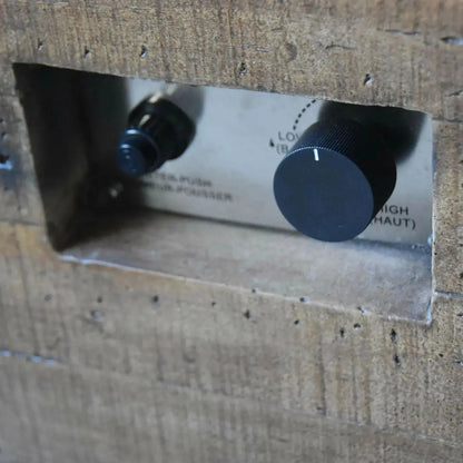 Black rotary knobs with textured surfaces on metallic panel for low and high settings on Elementi Modeno Wilton gas fire pit table