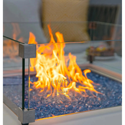 Modern glass-enclosed elementi plus bianco fire table with blue decorative stones and sleek metallic frame 16 kW ofp103bw