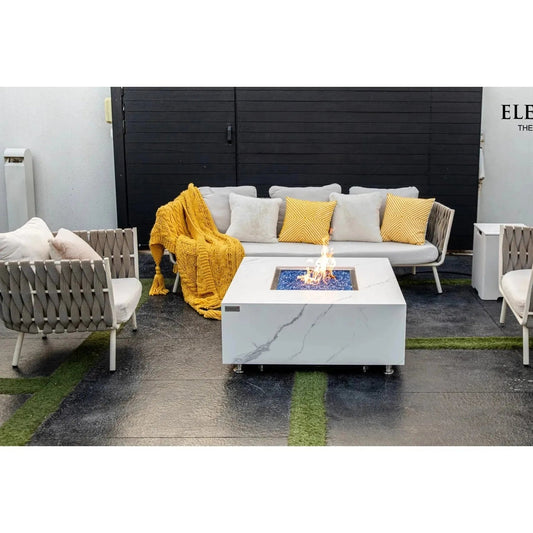 Elementi Plus Bianco fire table 16 kW white marble-effect square fire pit with blue glass beads and central flame