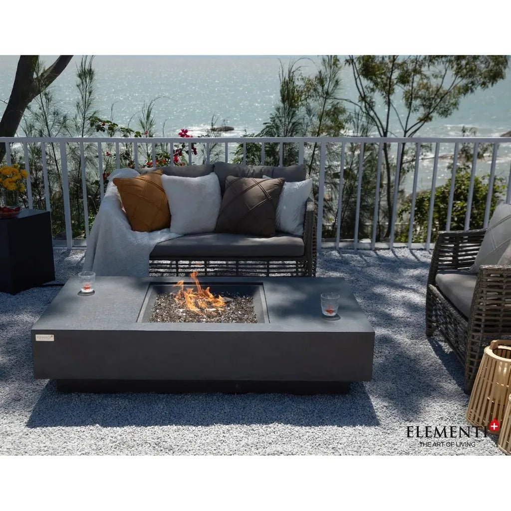 Modern dark gray rectangular Elementi Plus Cannes fire table with square flame-filled center and 16 kW output