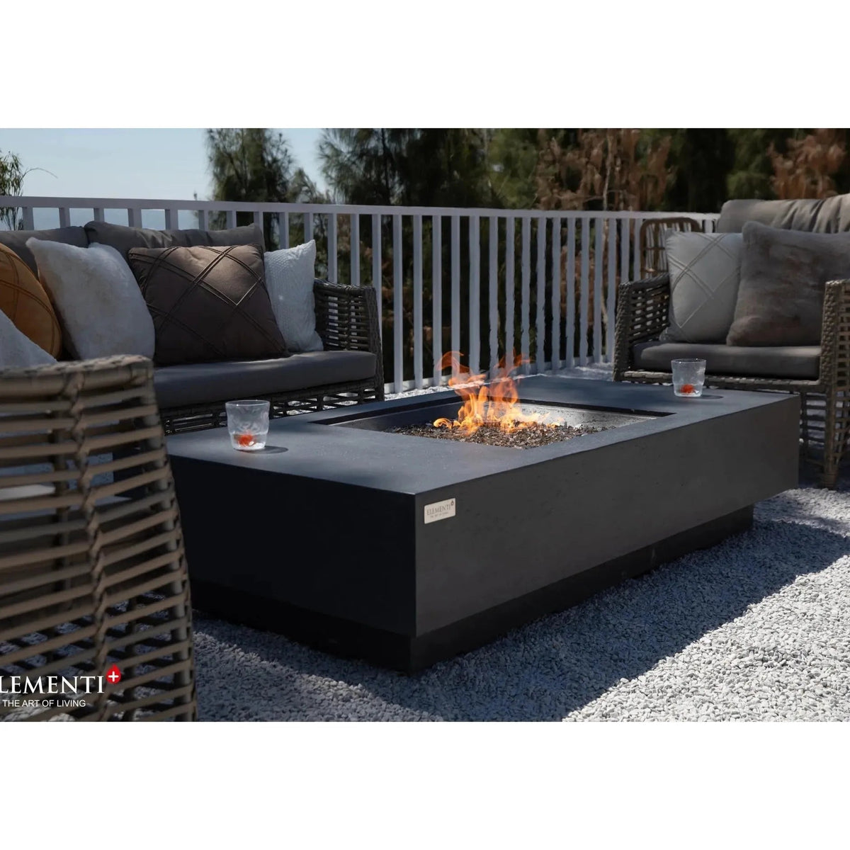 Elementi Plus Cannes fire table is a modern black rectangular fire pit with a minimalist design and glowing flames