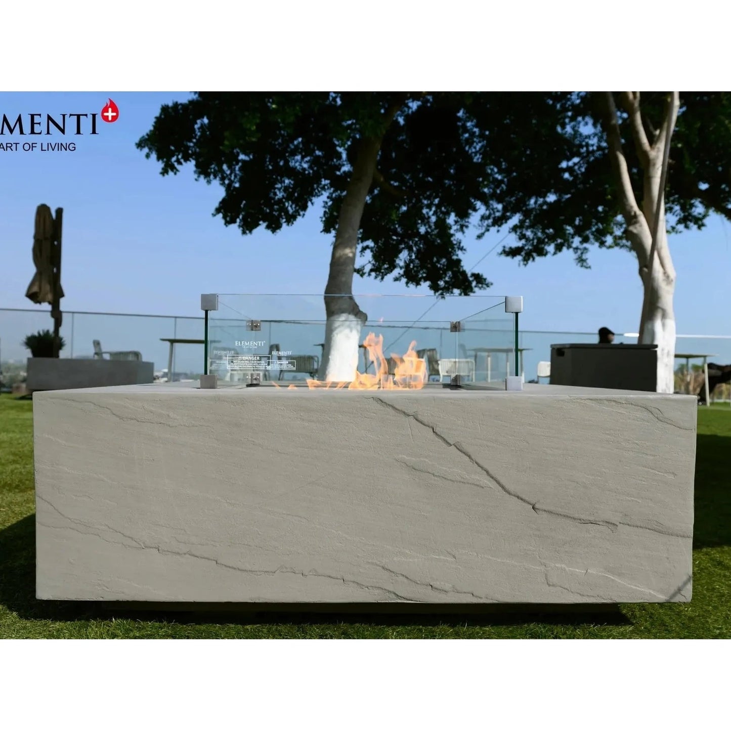 A sleek light gray concrete Elementi Plus Capertee fire table with modern design and subtle crackled texture 16 kW