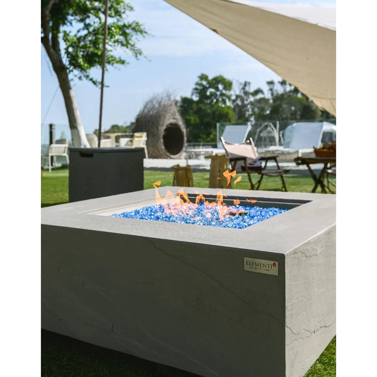 Elementi plus capertee fire table 16 kW gray concrete fire pit with blue glass beads and orange flames