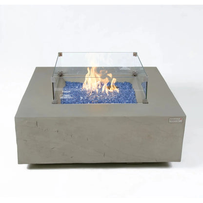 Gray concrete square fire pit with clear glass enclosure and blue flame glass beads elementi plus caperte fire table