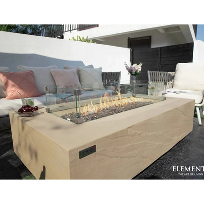 Beige stone fire pit table elementi plus colorado with glass enclosure and visible flame 16 kW ofg410sy model