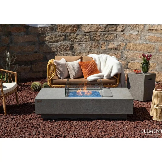 Gray concrete fire pit with blue glass beads and clear glass cover elementi plus monte carlo fire table 16 kw