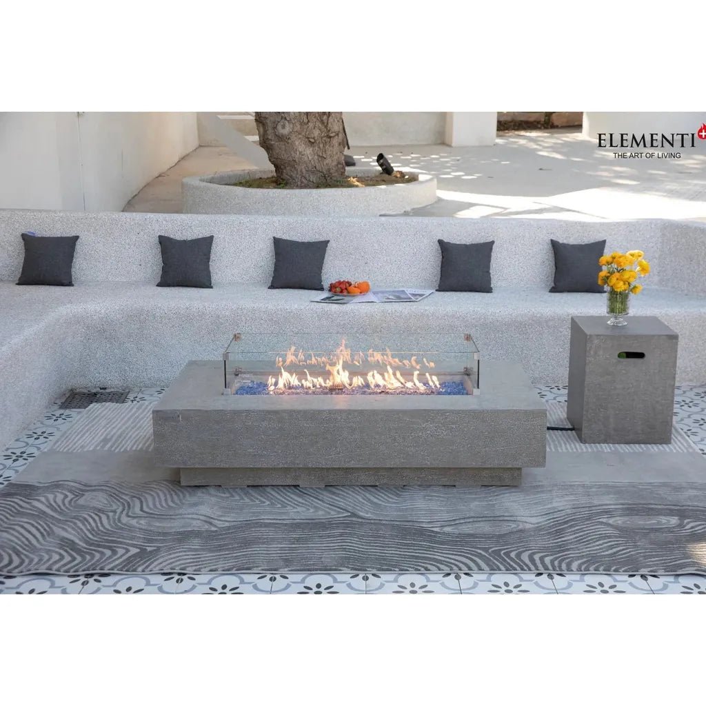 Gray concrete Elementi Plus Riviera fire table with glass enclosure and blue flameless fuel bed 16 kW OFG415LG