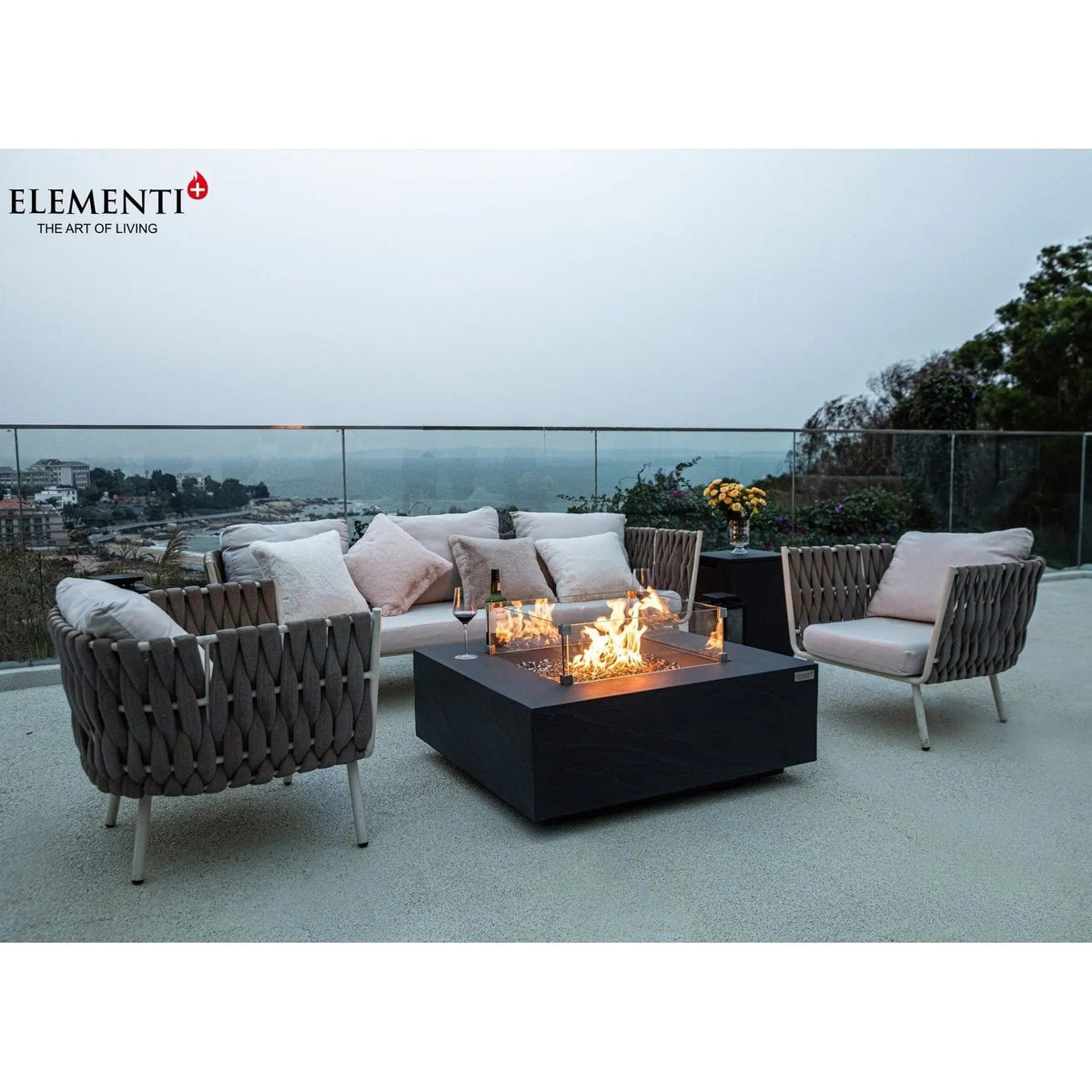 Black square Elementi Plus Roraima fire table with glass enclosure showing flames and 16 kW output