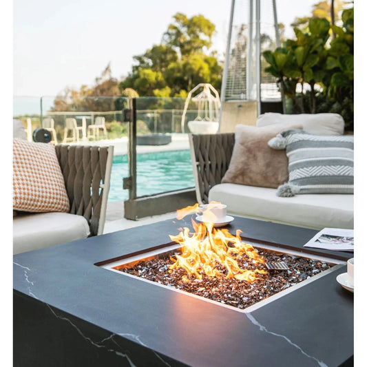 Black marble top Elementi Plus Sofia fire table with square flame feature and glass beads 16 kW OFP103BB