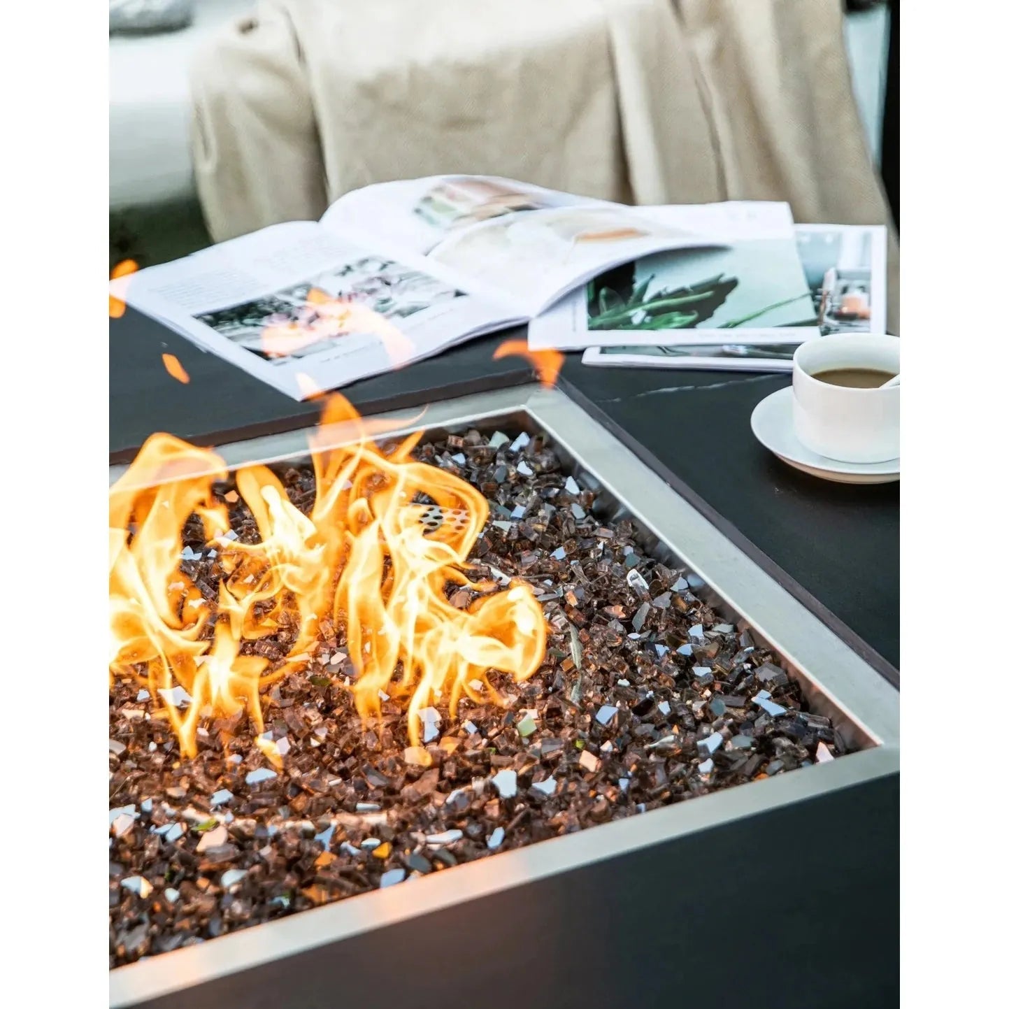 Elementi Plus Sofia fire table with a sleek black frame and dark reflective glass bead fire pit bed 16 kW OFP103BB