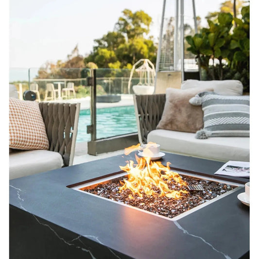Black marble top Elementi Plus Sofia fire table with square flame feature and glass beads 16 kW OFP103BB
