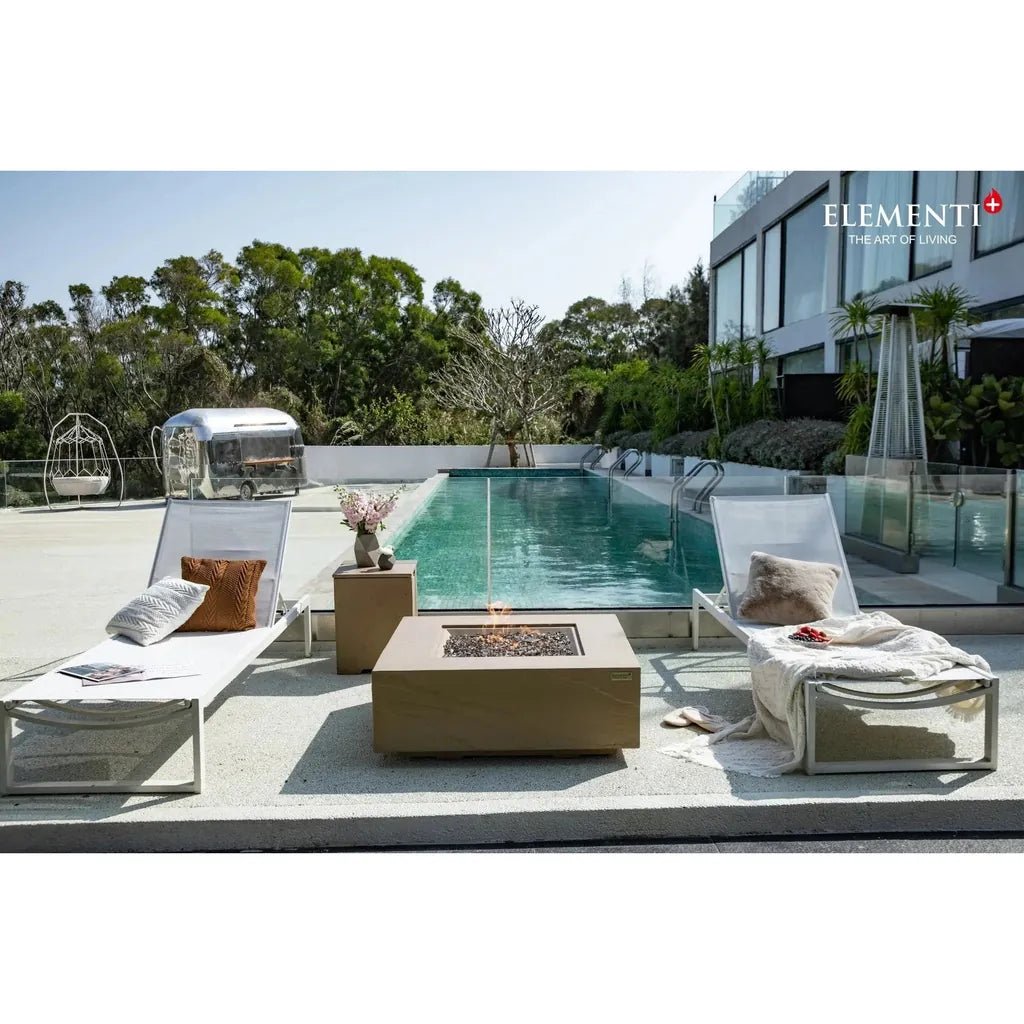 Beige square Elementi Plus Uluru fire table with glass top and glowing embers delivering 16 kW heat